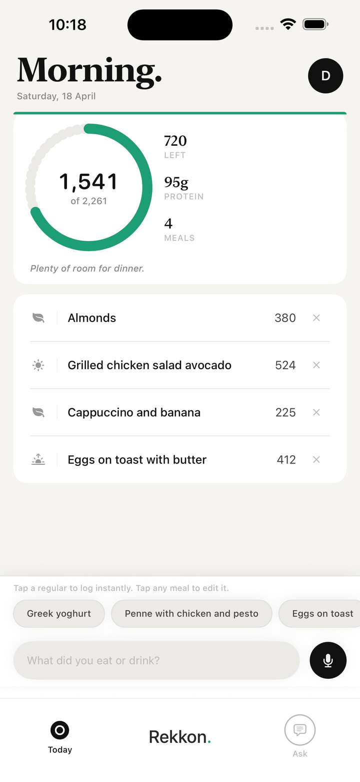 Rekkon Today screen: 1,541 of 2,261 calories, 720 left, 95g protein, four logged meals — almonds, grilled chicken salad with avocado, cappuccino and banana, eggs on toast — with the prompt ‘What did you eat or drink?’ and a microphone button